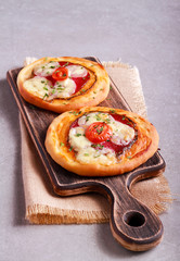 Salami, mozzarella mini pizza, on table