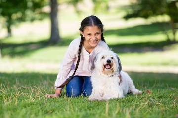 Portrait of smiling girl playing with her pet dog