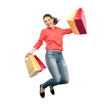 Smiling Young Woman With Shopping Bags Jumping