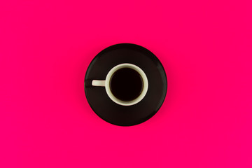 Coffee cup overhead on bright vivid pink background