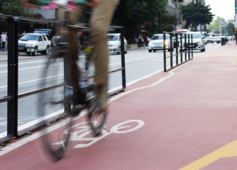 Motion blur of cyclist over red lane.