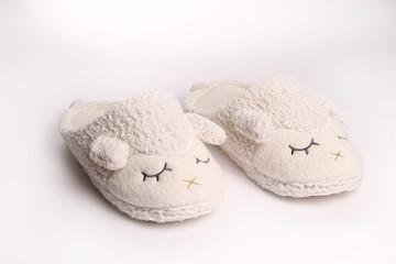 Women's slippers overlooking sheep isolated on white background 