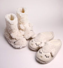 Women's slippers overlooking sheep isolated on white background 