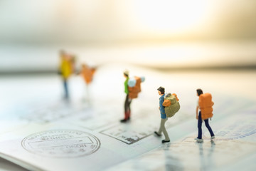 Travelling concepts. Group of traveler miniature mini figures wi - obrazy, fototapety, plakaty