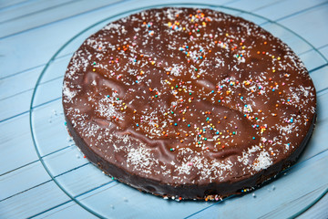 Piece of homemade chocolate cake on the wood background