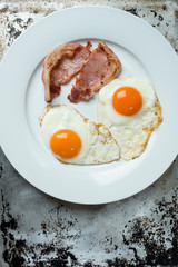 Bacon and Eggs in White Plate with Copy Space