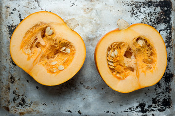Pumpkin Halves with Insides Exposed on Aluminium Surface