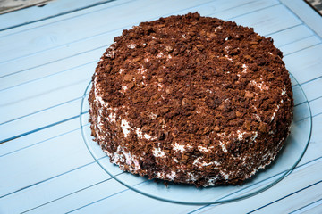 Piece of homemade chocolate cake on the wood background