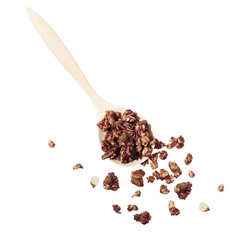 wooden spoon with scatter around healthy chocolate granola cerea