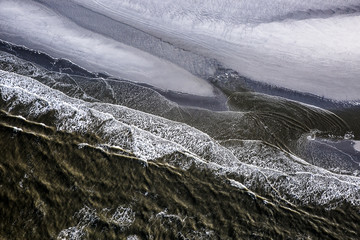 Aerial view of the shore with shapes, lines and patterns formed by the waves on the sand, Ameland...
