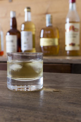 glass with whisky on wooden table