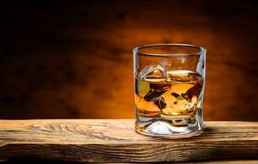 whiskey with ice on a wooden table