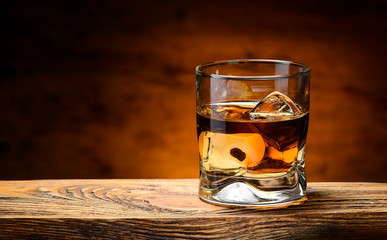 whiskey with ice on a wooden table