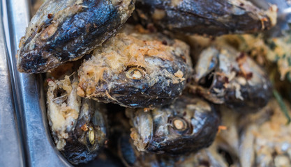 Close up Fried fish in a frying pan .(Selective focus)