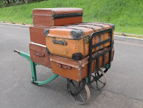 Old Suitcases on a Vintage Railway Luggage Trolley.