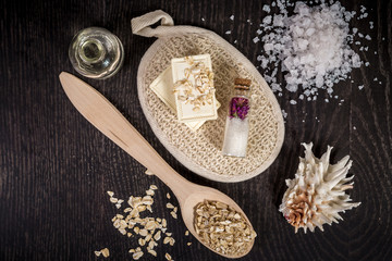 cosmetics for spa on dark background top view