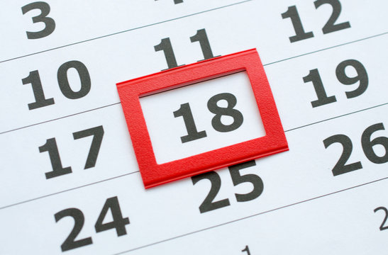 White paper calendar with the number 18 in the red box