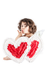 Little curly angel sitting half-turned, and sends a kiss to the camera. Close-up. White background.