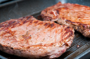 Steak dinner cooking on the grill