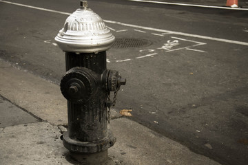 Fototapeta na wymiar Dirty fire hydrant on the street in vintage style