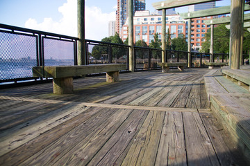 Wood walkway and bench next to the water