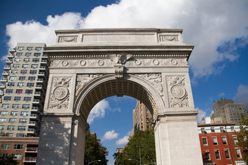Fototapeta na wymiar Washington Square Park Arch and buildings with cloudy blue sky