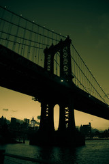 Manhattan bridge in silhouette in green vintage color style