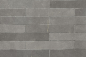 Detail of a wall of a long gray brick.