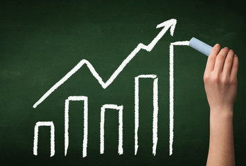 Hand drawing graph on blackboard