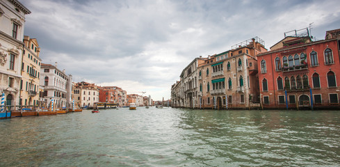 Fototapeta na wymiar ITALY, VENICE - MAY 06, 2012: Grand Canal view. Traditional houses and boats