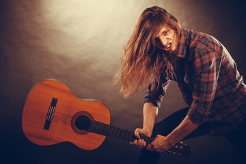 Rock musician destroys his guitar.