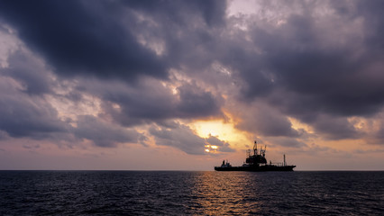 Drilling rig in Sunset