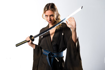 Blonde woman dressed like samurai with a katana © luismolinero