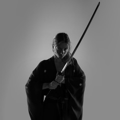 Blonde woman dressed like samurai with a katana