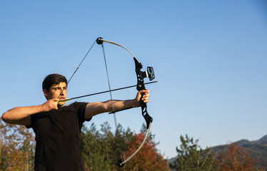 Archer draws his compound bow