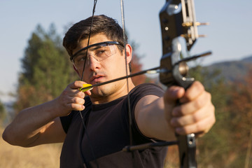 Archer draws his compound bow