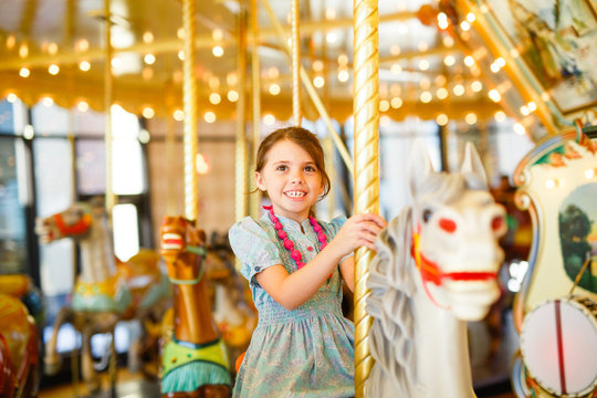 Girl riding carousel 