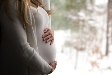 Pregnant woman holding tummy