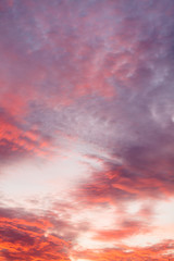 Naklejka na ściany i meble Colorful vibrant clouds on sky at sunset
