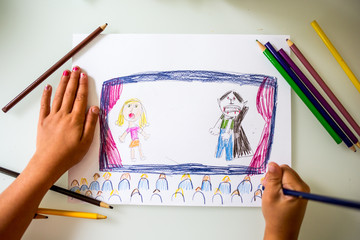 Childs drawing of figures on stage 