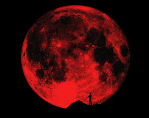 Men's silhouette against the background of the full moon. lonely man.