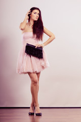 Fototapeta premium woman bright dress heeled shoes clutch in hand