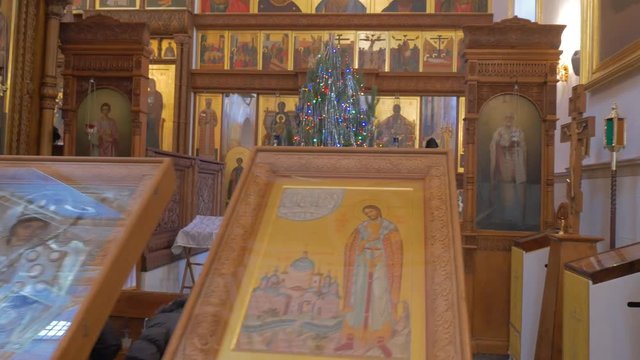 a Magnificent Iconostasis of an Orthodox Church and People Praying Before it on the Eve of New Year`s Day