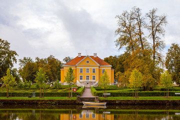 Beautiful and rich Palmse Manor in Estonia. Green bushes in park in front of manor.