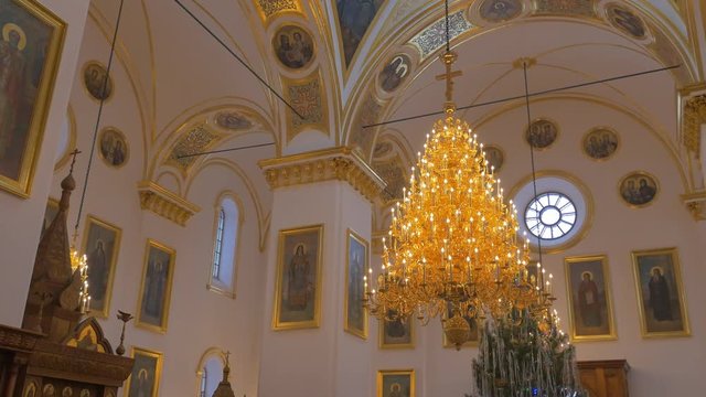 Very Impressive Golden Looking Church Chandelier and Beautiful High Dome Ceiling With Images of Different Sains in an Orthodox Cathedral
