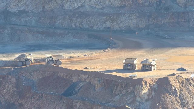 Huge dump trucks in operation at a mining site