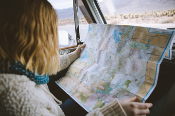Woman holding map in a car