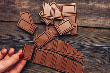 broken dark chocolate on a wooden background
