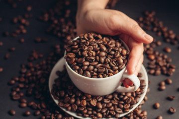 coffee beans in a cup and saucer