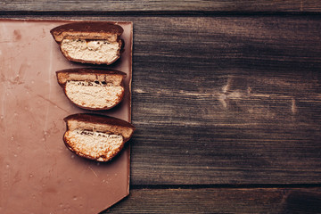 Slices of bread lie on a wooden board, dark background